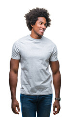 Sticker - Afro american man over isolated background looking away to side with smile on face, natural expression. Laughing confident.