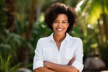 Portrait of a blissful afro-american woman in her 40s wearing a classic white shirt isolated on tranquil coral reef background
