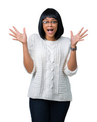 Wall Mural - Beautiful young african american woman wearing glasses over isolated background celebrating crazy and amazed for success with arms raised and open eyes screaming excited. Winner concept