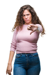 Sticker - Beautiful brunette curly hair young girl wearing pink sweater over isolated background looking unhappy and angry showing rejection and negative with thumbs down gesture. Bad expression.