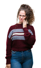 Canvas Print - Beautiful brunette curly hair young girl wearing glasses over isolated background touching mouth with hand with painful expression because of toothache or dental illness on teeth. Dentist concept.