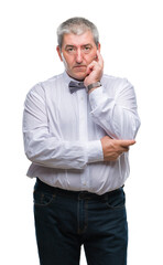 Canvas Print - Handsome senior man wearing bow tie over isolated background thinking looking tired and bored with depression problems with crossed arms.