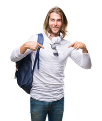 Canvas Print - Young handsome tourist man with long hair wearing backpack over isolated background looking confident with smile on face, pointing oneself with fingers proud and happy.