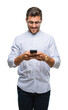 © Krakenimages.com - Young handsome man texting using smartphone over isolated background with a happy face standing and smiling with a confident smile showing teeth