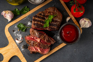 Wall Mural - Grilled beef steak on wooden cutting board