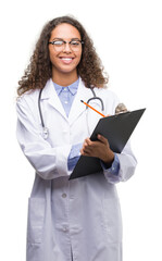 Sticker - Young hispanic doctor woman holding a clipboard with a happy face standing and smiling with a confident smile showing teeth