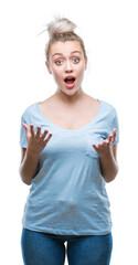 Wall Mural - Young blonde woman over isolated background afraid and shocked with surprise expression, fear and excited face.