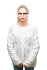 Wall Mural - Young beautiful blonde woman wearing glasses over isolated background skeptic and nervous, frowning upset because of problem. Negative person.