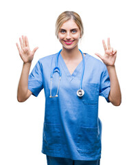 Canvas Print - Young beautiful blonde doctor surgeon nurse woman over isolated background showing and pointing up with fingers number eight while smiling confident and happy.