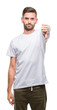 © Krakenimages.com - Young handsome man over isolated background looking unhappy and angry showing rejection and negative with thumbs down gesture. Bad expression.