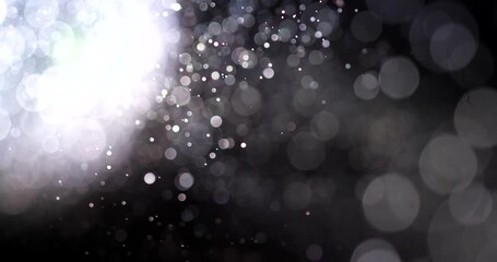 Abstraction of light particles on black background.
