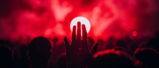 Sticker -  A throng of concert-goers, arms aloft, amidst a radiant crimson backdrop