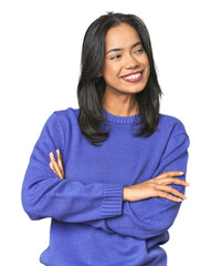 Wall Mural - simple portrait of a young latina smiling confident with crossed arms.