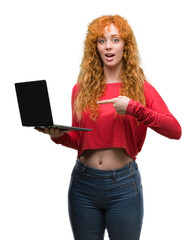 Sticker - Young redhead woman using computer laptop very happy pointing with hand and finger