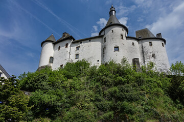 Wall Mural - View of Clervaux Castle (Chateau de Clervaux) in Clervaux in Northern Luxembourg, dates back to XII century. Castle stands at a height of 365 meters on a rocky spur above town. Clervaux, Luxembourg.