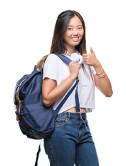 Sticker - Young asian woman wearing backpack and headphones over isolated background happy with big smile doing ok sign, thumb up with fingers, excellent sign