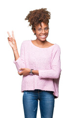 Wall Mural - Beautiful young african american woman wearing glasses over isolated background smiling with happy face winking at the camera doing victory sign. Number two.