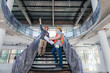 © skarie - Engineer or Architect discussing with contractor about project on stairs in building construction site.