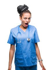 Poster - Young braided hair african american girl professional surgeon over isolated background afraid and shocked with surprise expression, fear and excited face.