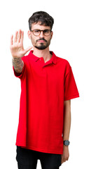 Wall Mural - Young handsome man wearing glasses over isolated background doing stop sing with palm of the hand. Warning expression with negative and serious gesture on the face.