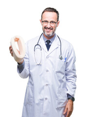 Wall Mural - Middle age senior hoary doctor man holding neck collar over isolated background with a happy face standing and smiling with a confident smile showing teeth