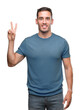© Krakenimages.com - Handsome young casual man showing and pointing up with fingers number two while smiling confident and happy.
