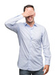 © Krakenimages.com - Handsome young businessman smiling and laughing with hand on face covering eyes for surprise. Blind concept.