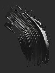 Wall Mural - A black brush stroke on a dark background. The brush stroke is long and thin, and it is made of black paint. The brush stroke is the main focus of the image, and it creates a sense of movement