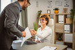 © Miljan Živković - Man handshake greeting with woman on job interview at office
