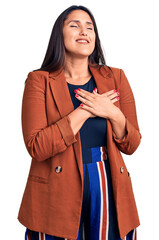 Poster - Young beautiful brunette woman wearing elegant clothes smiling with hands on chest with closed eyes and grateful gesture on face. health concept.