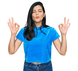 Wall Mural - Young hispanic woman wearing casual clothes relax and smiling with eyes closed doing meditation gesture with fingers. yoga concept.