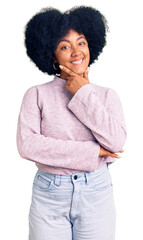 Sticker - Young african american girl wearing casual clothes looking confident at the camera smiling with crossed arms and hand raised on chin. thinking positive.