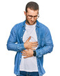 © Krakenimages.com - Young caucasian man wearing casual clothes with hand on stomach because indigestion, painful illness feeling unwell. ache concept.