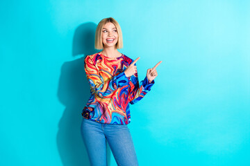 Poster - Photo of cheerful girl with bob hairstyle dressed print shirt indicating look at sale empty space isolated on blue color background