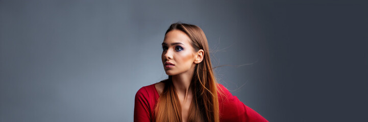 Wall Mural - worry young woman red shirt studio portrait