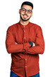 © Krakenimages.com - Young hispanic man with beard wearing business shirt and glasses happy face smiling with crossed arms looking at the camera. positive person.