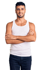 Sticker - Young hispanic man wearing casual clothes happy face smiling with crossed arms looking at the camera. positive person.