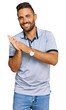 © Krakenimages.com - Handsome man with beard wearing casual clothes clapping and applauding happy and joyful, smiling proud hands together