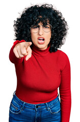 Canvas Print - Young middle east girl wearing casual clothes and glasses pointing displeased and frustrated to the camera, angry and furious with you