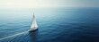 © mikeosphoto - A sailboat with white sails navigates the calm, expansive blue sea under a clear sky, creating a serene and peaceful atmosphere