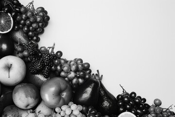 Wall Mural - A black and white photo of a variety of fruits, including apples, oranges, and grapes. The fruits are piled on top of each other, creating a visually appealing and colorful display