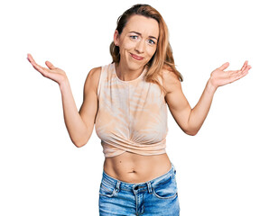 Canvas Print - Young caucasian woman wearing casual style with sleeveless shirt clueless and confused with open arms, no idea and doubtful face.