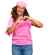 © Krakenimages.com - Middle age hispanic woman wearing breast cancer support pink scarf smiling in love showing heart symbol and shape with hands. romantic concept.