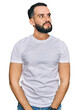 © Krakenimages.com - Young man with beard wearing casual white t shirt smiling looking to the side and staring away thinking.