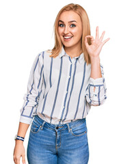 Wall Mural - Beautiful caucasian woman wearing casual clothes smiling positive doing ok sign with hand and fingers. successful expression.