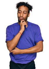 Sticker - Young african american man with beard wearing casual purple t shirt with hand on chin thinking about question, pensive expression. smiling with thoughtful face. doubt concept.