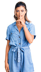 Sticker - Young beautiful woman wearing casual clothes asking to be quiet with finger on lips. silence and secret concept.