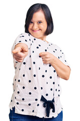 Poster - Brunette woman with down syndrome wearing casual clothes pointing fingers to camera with happy and funny face. good energy and vibes.