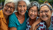© Maestro - Joyful senior women friends smiling together in an outdoor setting