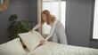 © Krakenimages.com - Young caucasian woman arranging pillows in a modern bedroom, conveying a sense of home, tranquility, and indoor comfort.